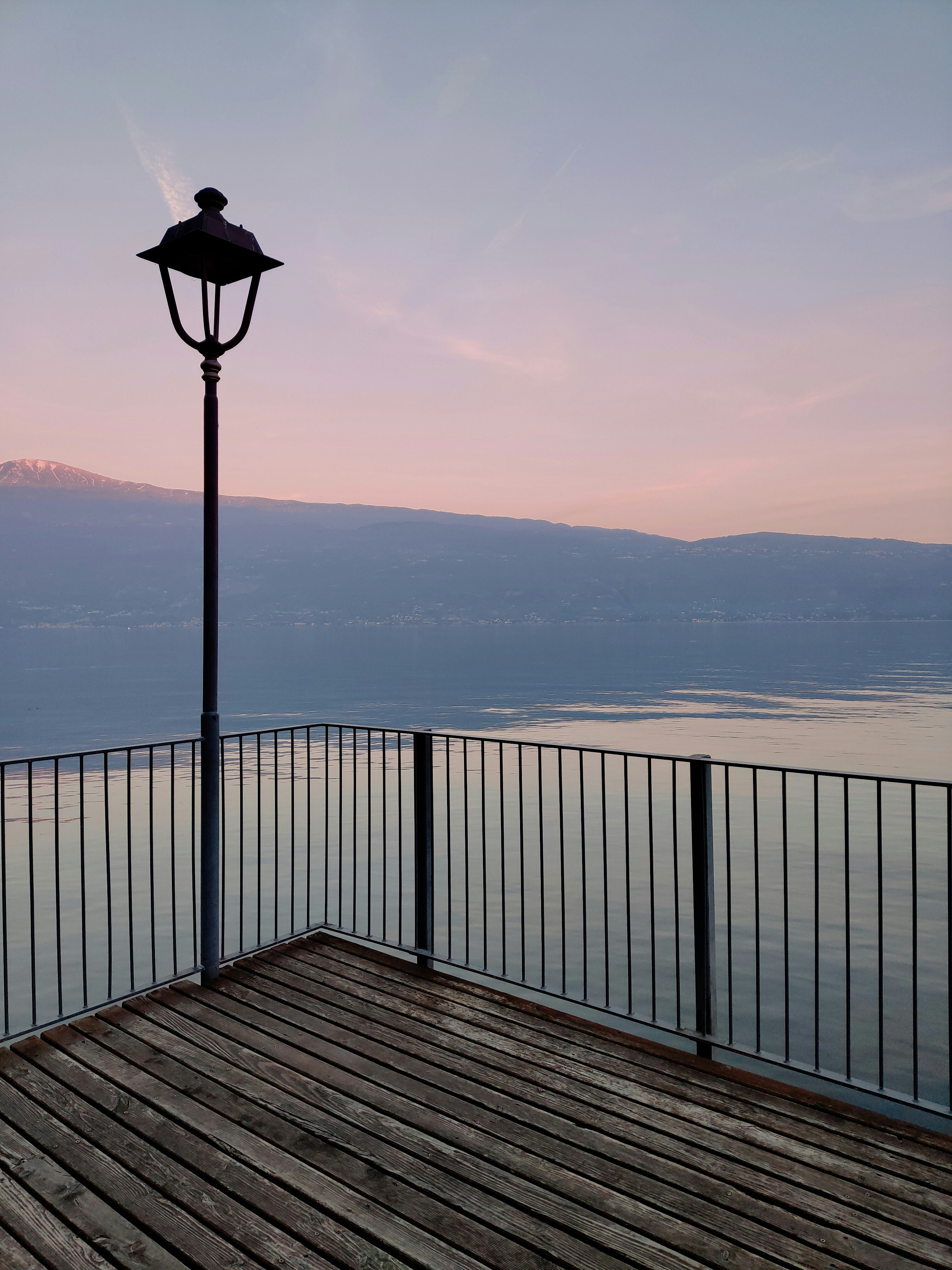 black and white lamp post on brown wooden dock during daytime